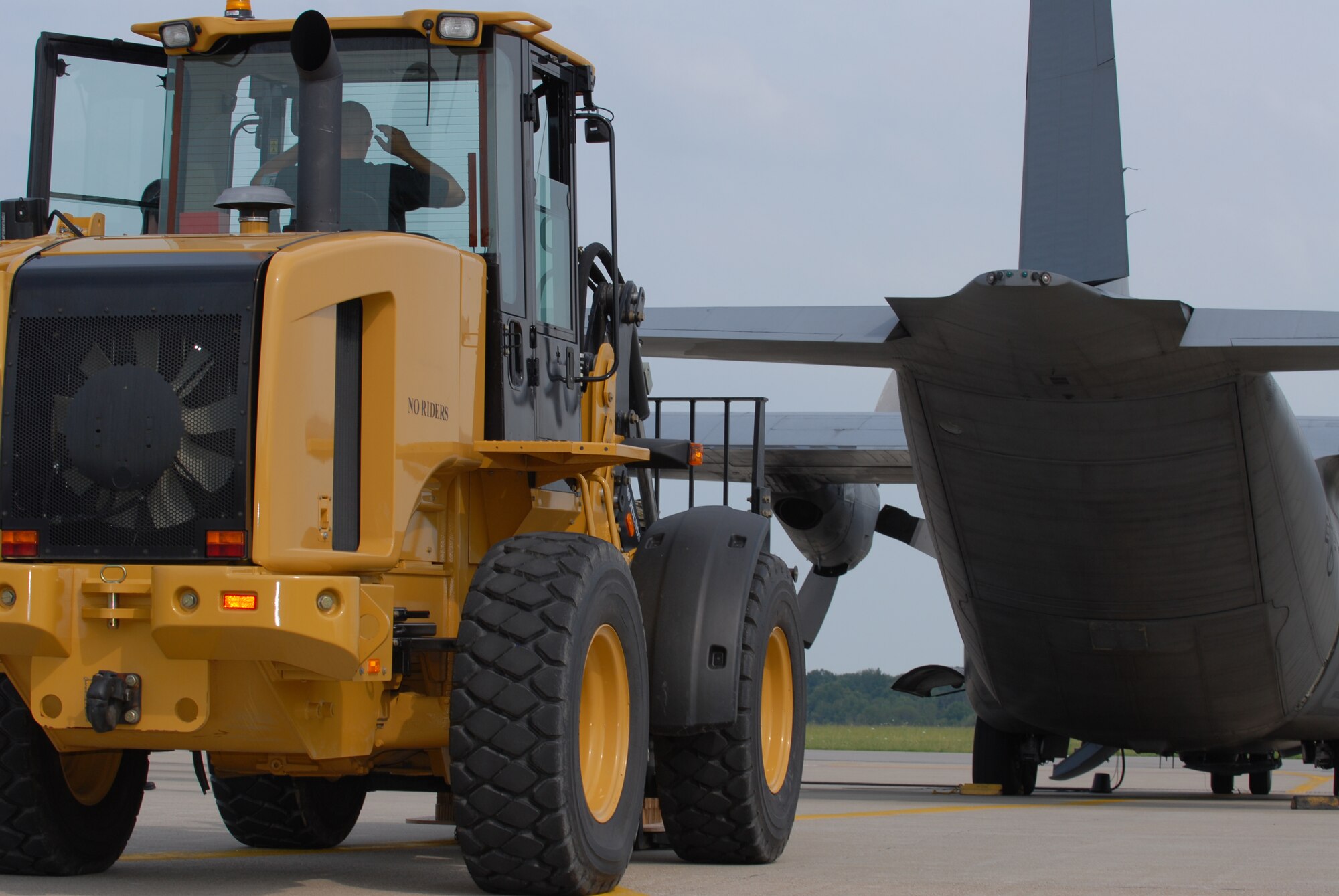 Members of the 179th Ariel Port Squadron load cargo into C-130 aircraft at Mansfield Lahm Airport, Mansfield, Ohio on July 9, 2008. The Ariel Port Airman are supporting an Air Rodeo competition where pilots display their skills in air drops and landing precision. (Air Force photo by Staff Sgt Robert Koehler) (Released)