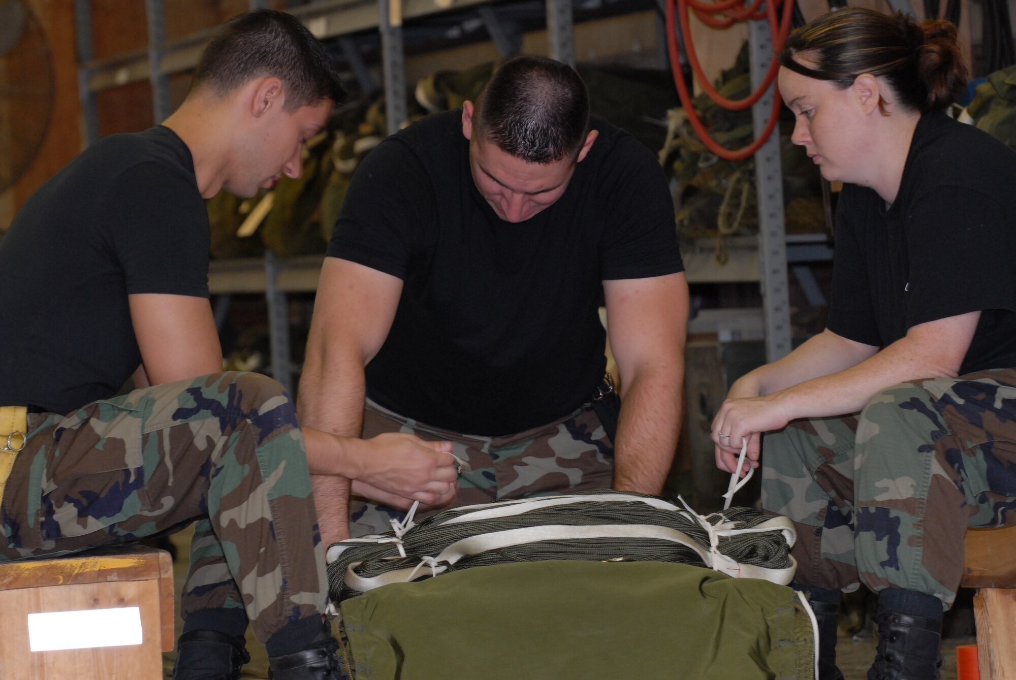 Members of the 179th Ariel Port Squadron prepare tactical parachutes for dropping cargo from C- 130 aircraft at Mansfield Lahm Airport, Mansfield, Ohio on July 9, 2008. The Ariel Port Airman are supporting an Air Rodeo competition where pilots display their skills in air drops and landing precision. (Air Force photo by Staff Sgt Robert Koehler) (Released)