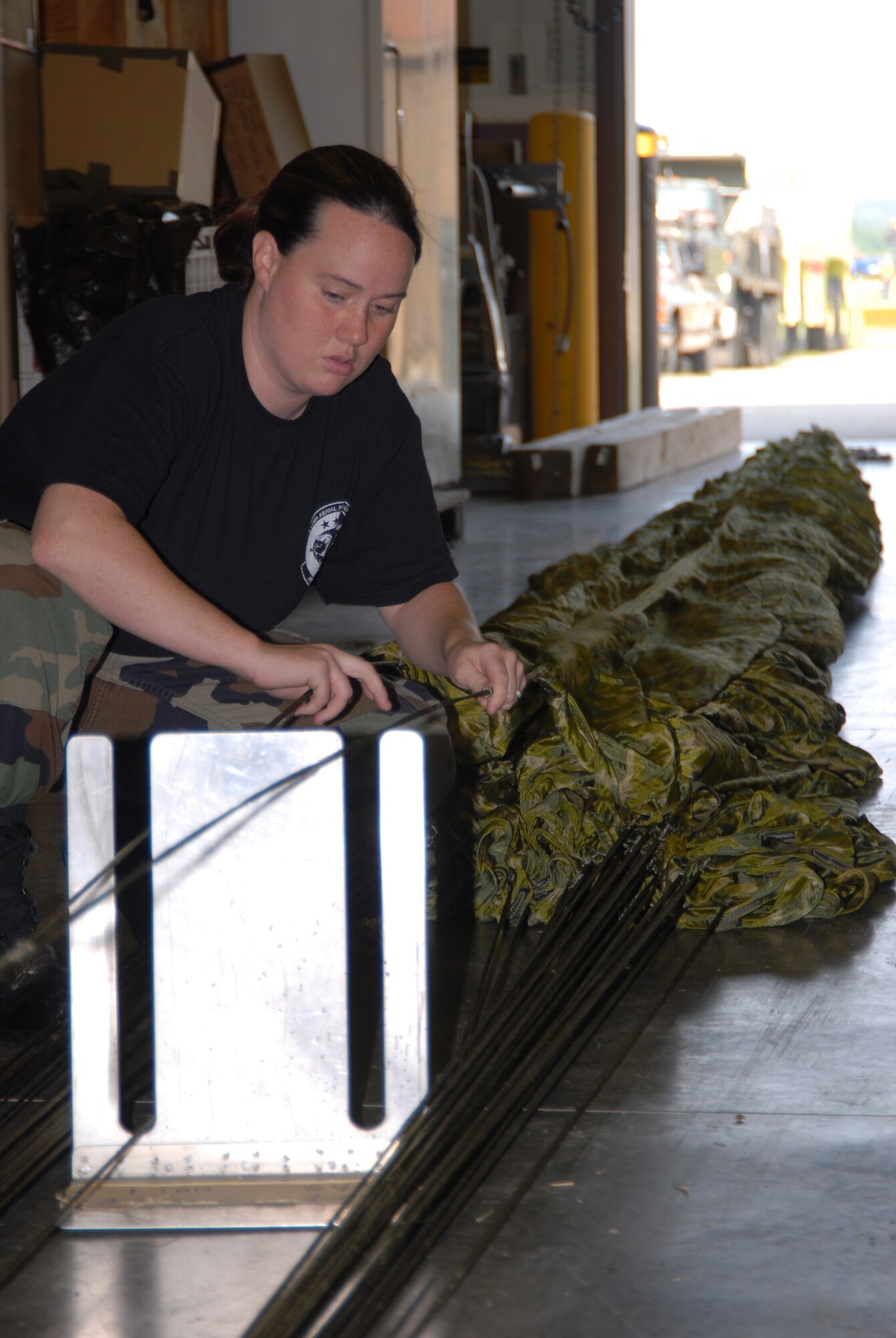 Members of the 179th Ariel Port Squadron prepare tactical parachutes for dropping cargo from C-130 aircraft at Mansfield Lahm Airport, Mansfield, Ohio on July 9, 2008. The Ariel Port Airman are supporting an Air Rodeo competition where pilots display their skills in air drops and landing precision. (Air Force photo by Staff Sgt Robert Koehler) (Released)