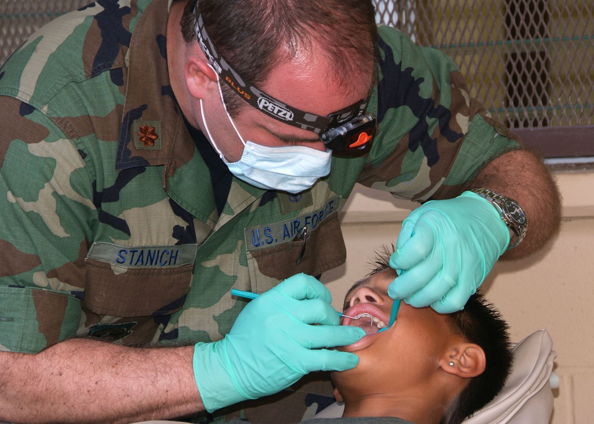 Ohio Air National Guard doctor, Major Kevin Stanich from the 179th Airlift Wing, does a routine dental check up for a Waianae student in the state of Hawaii. (U.S. Air Force photo by Technical Sgt. Lisa Haun) (Released)