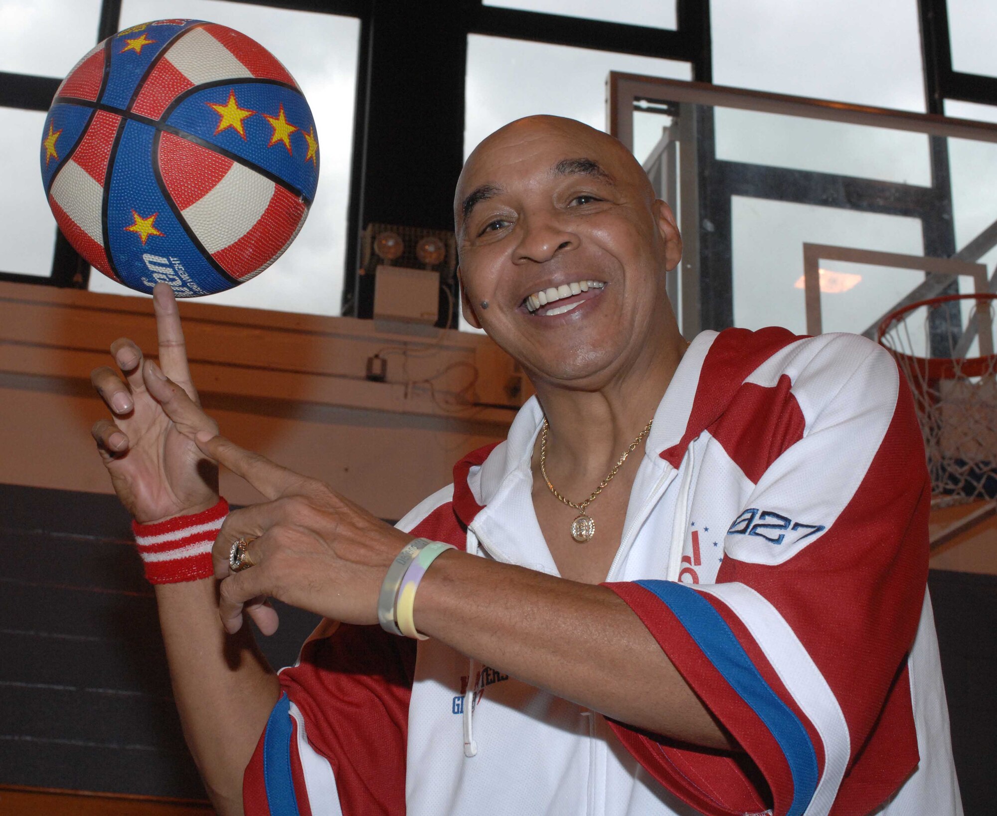 Harlem Globetrotters legend Curley Neal shows off some moves for the troops at RAF Mildenhall Aug. 17 on his Extreme Summer tour through USAFE. Mr.Curly was a Harlem Globetrotters superstar through the 70s and 80s and was known as Fred "Curley" Neal. (U.S Air Force photo by Airman First Class Brad Smith)