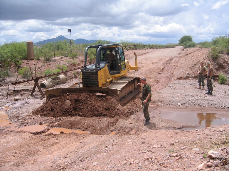 Road crews repair a washout on an access road that runs along the U.S.-Mexican border. The road is used by Border Patrol agents to monitor illegal entries.
(Chief Master Sgt. Steve Peters/KyANG)