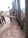 Airman 1st Class Nick Ketterer sends hand signals to the operator of a cement truck to
control the flow of concrete as it pours into forms along the fence line.
(Maj. John Cassel/KyANG)