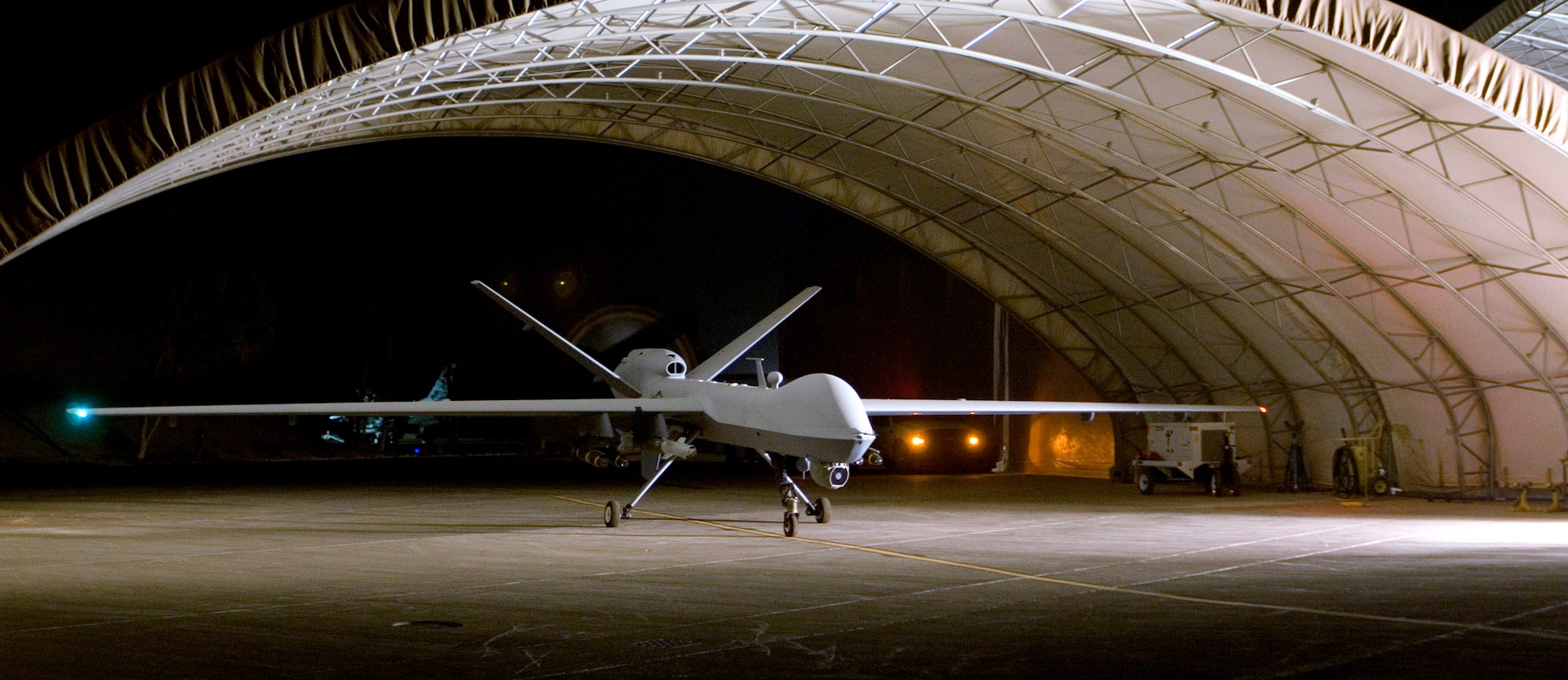 An MQ-9 Reaper remotely piloted aircraft prepares to taxi out of a hangar Aug. 8 at Joint Base Balad, Iraq. A Reaper employed a 500-pound GBU-12 laser-guided bomb against anti-Iraqi forces Aug. 16, marking the Reaper's first weapons engagement since it began flying combat sorties over Iraq July 18. (U.S. Air Force photo/Tech. Sgt. Erik Gudmundson) 
