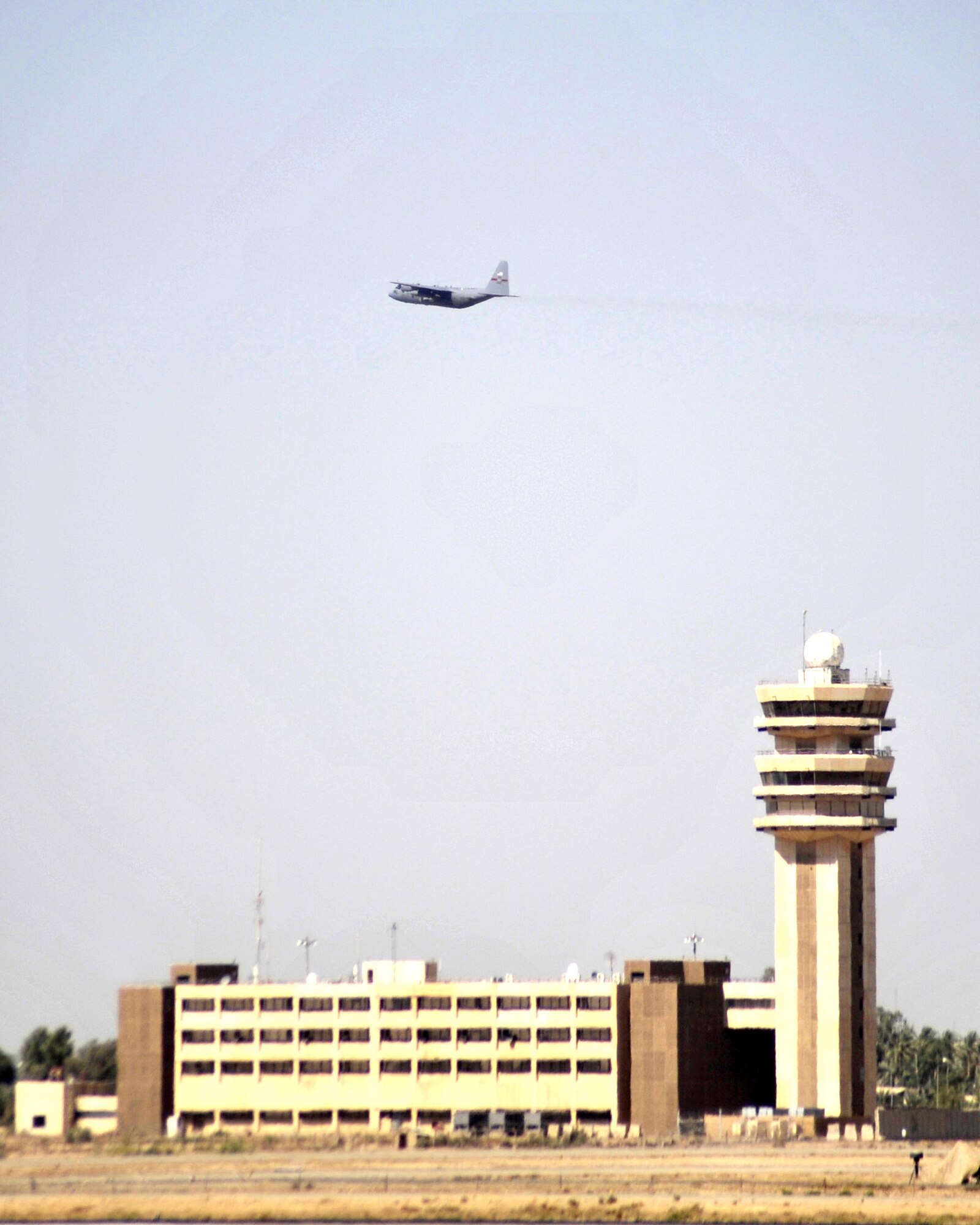 8/14/2008 - SATHER AIR BASE, Iraq ? An Air Force C-130 Hercules aircraft wings its way over Baghdad International Airport to bring the body of Cpl. James Hale home from Iraq. Soldiers from the 978th Military Police Company and Airmen from the 447th Air Expeditionary Group gathered at Sather Air Base, just west of the Baghdad airport to provide patriot honors to Corporal Hale, who was killed July 13 in Baghdad by a roadside bomb. The patriot ceremony marks the beginning of the journey home for U.S. service members killed while serving in deployed locations. (U.S. Air Force Photo by Master Sgt. Brian Davidson)