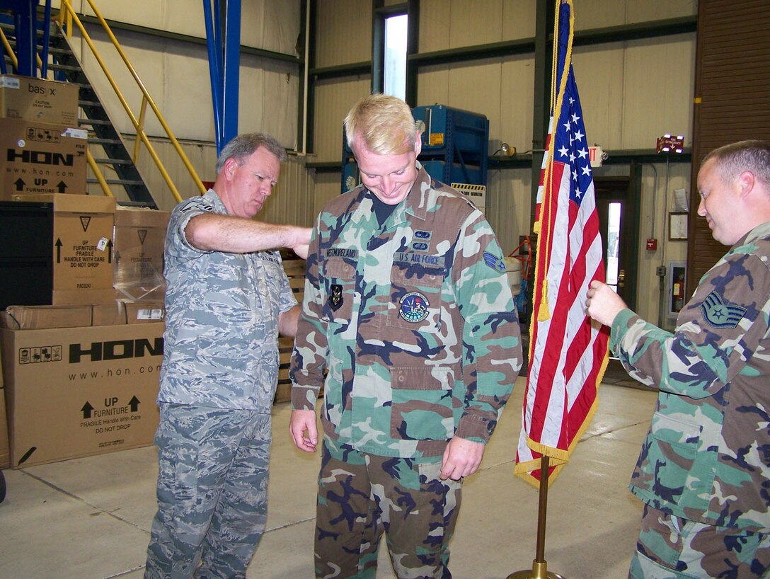 SEYMOUR JOHNSON AIR FORCE BASE, N.C. -- Newly promoted Richard Westmoreland (center) receives his staff sergeant stripes from Master Sgt. William Welch (left) and Staff Sgt. Jamie Mozingo during the August unit training assembly. Staff Sgt. Westmoreland is a structural repair technician with the 916th Maintenance Squadron.