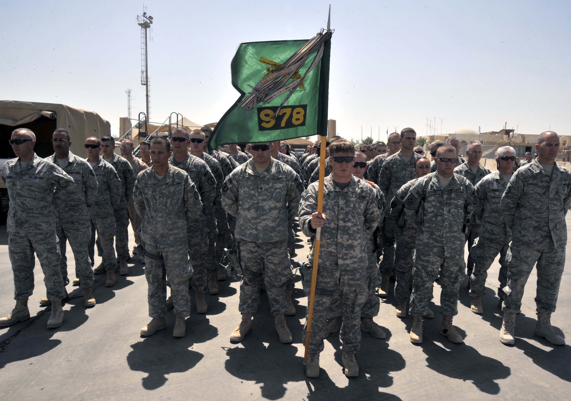 8/14/2008 - SATHER AIR BASE, Iraq - Soldiers from the 978th Military Police Company and Airmen from the 447th Air Expeditionary Group wait to render patriot honors for a Soldier killed in combat. The unofficial ceremony takes place whenever the body of a U.S. service member who is killed while deployed is brought to the airfield to begin the journey home. (U.S. Air Force Photo by Master Sgt. Brian Davidson)