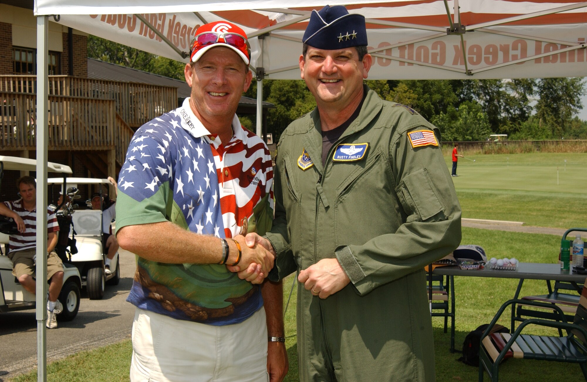 SCOTT AIR FORCE BASE, Ill. -- Lt. Gen. Vern Findley (right), Air Mobility Command vice commander, coins Professional Golfer’s Association tour professional Woody Austin at the 2008 Chief’s Group Golf Tournament. General Findley also received an autographed hat and golf ball from Mr. Austin.
(US Air Force photo/Airman 1st Class Amber Kelly-Woodward)

