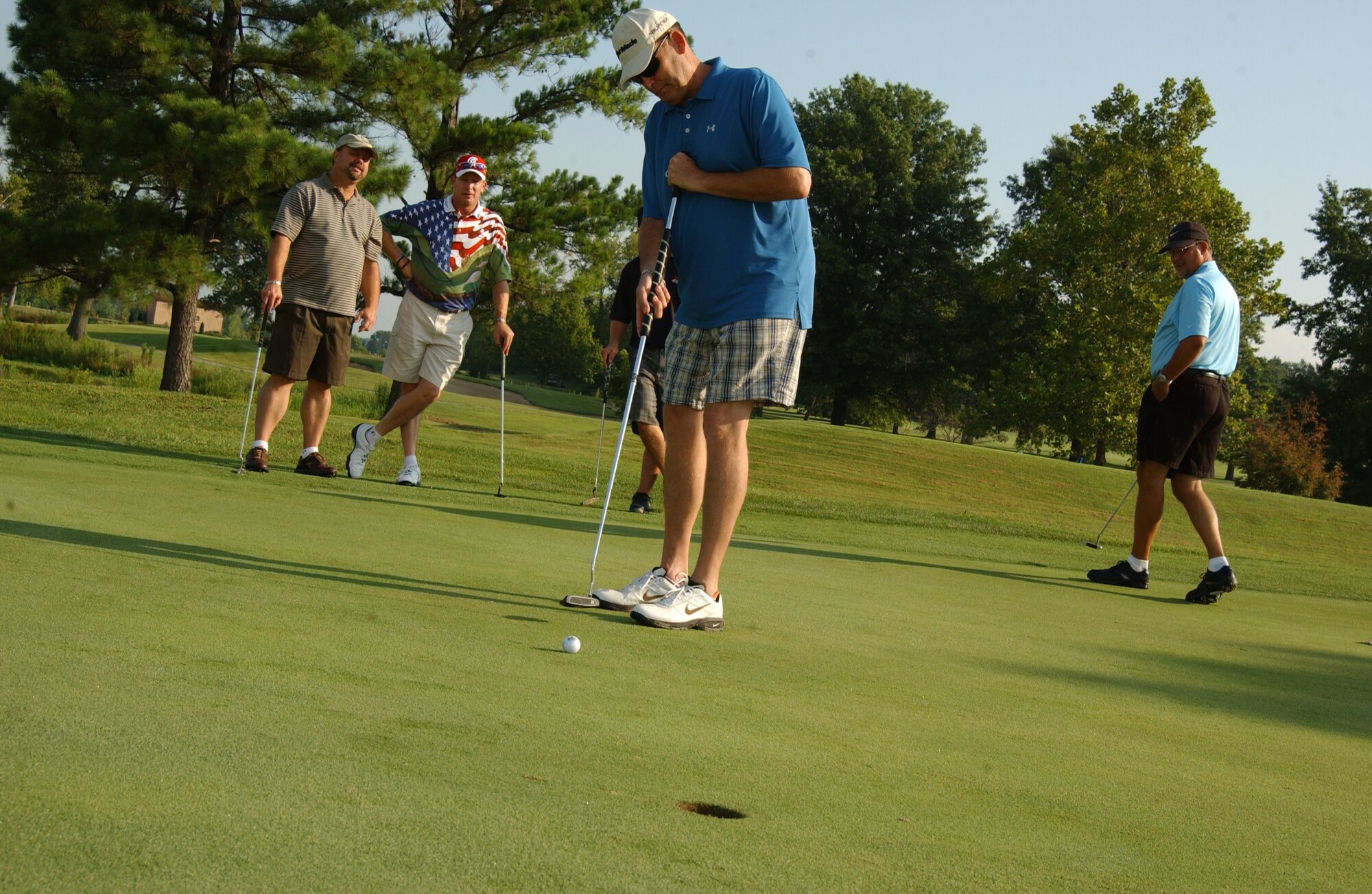SCOTT AIR FORCE BASE, Ill. -- Air Mobility Command deputy command chaplain, Col. (Ch.) Jerry Lewis, putts on hole 10 attempting to beat Professional Golfer’s Association tour profession Woody Austin. Less than 10 people were able to beat Mr. Austin. 
(US Air Force photo/Airman 1st Class Amber Kelly-Woodward)
