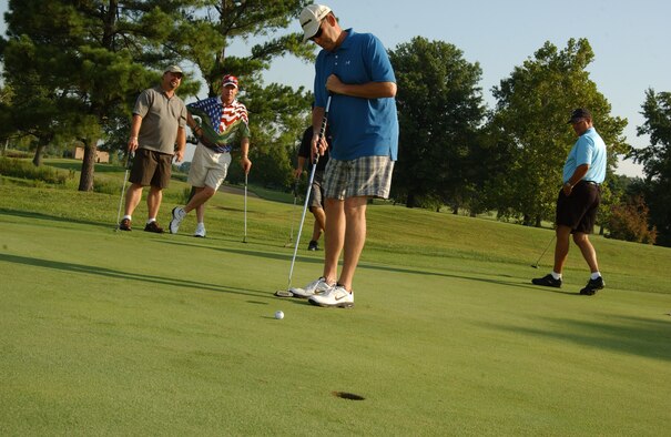 SCOTT AIR FORCE BASE, Ill. -- Air Mobility Command deputy command chaplain, Col. (Ch.) Jerry Lewis, putts on hole 10 attempting to beat Professional Golfer’s Association tour profession Woody Austin. Less than 10 people were able to beat Mr. Austin. 
(US Air Force photo/Airman 1st Class Amber Kelly-Woodward)
