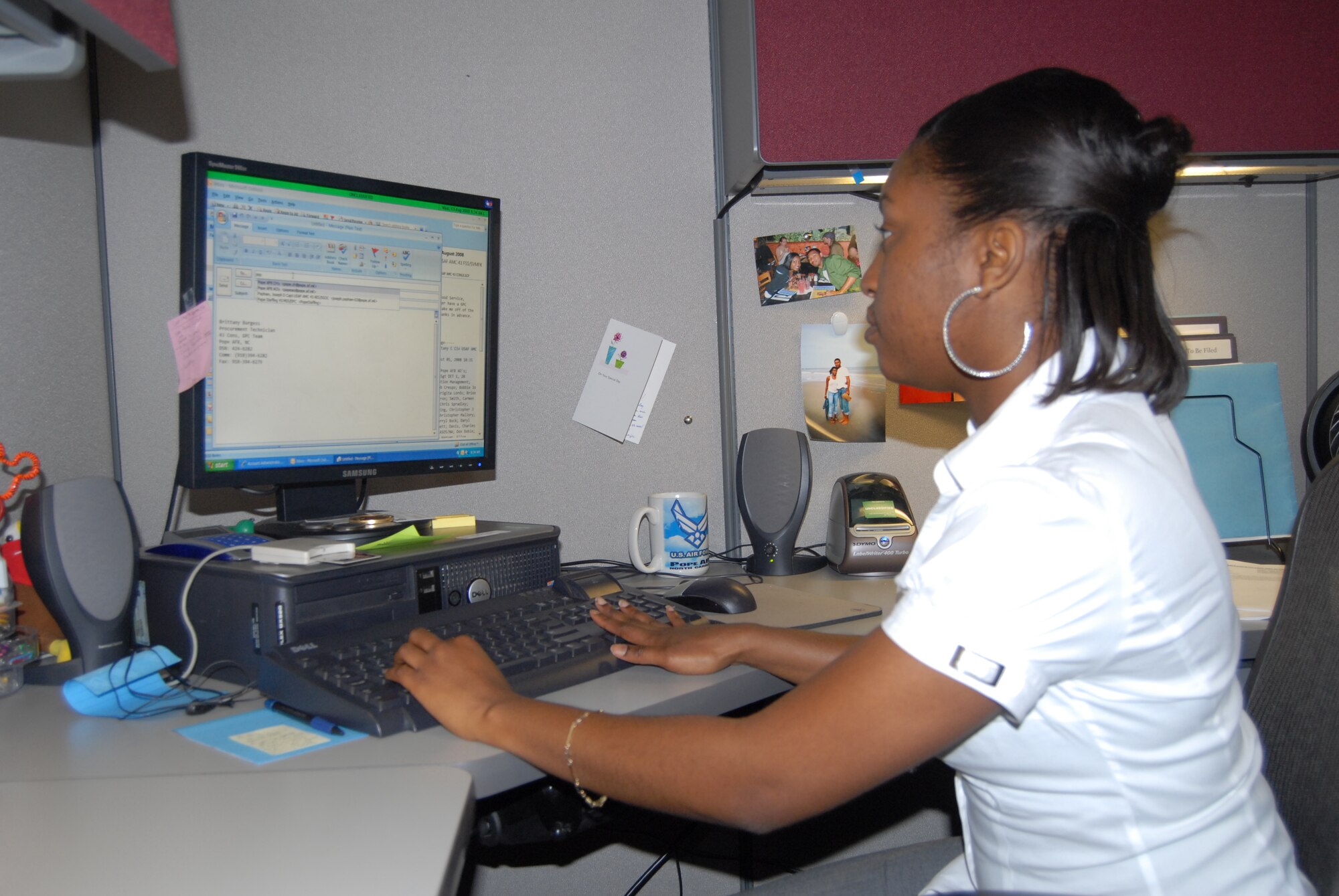 Brittany Burgess, 43rd Contracting Squadron, works to complete Government Purchase Card request Aug. 13 at her workstation. (U.S. Air Force Photo by Emily Smith)