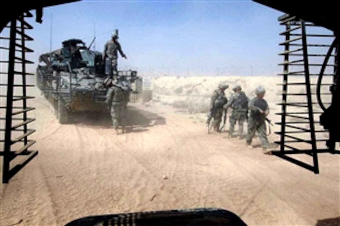 U.S. Army soldiers blow fine sand from their weapons after returning to Forward Operating Base Warhorse from a mission in Baqubah, Iraq, Aug. 18, 2008. The soldiers area ssigned to 2nd Battalion, 2nd Stryker Cavalry Regiment. Referred to by soldiers as "moon dust," the sand has the consistency of talcum powder. 
