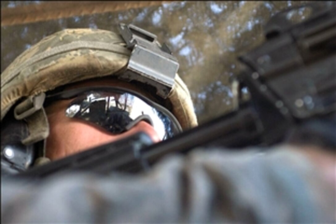 U.S. Army Spc. Christopher Thompson maintains a vigilant watch during a routine mission in Baqubah, Iraq, Aug. 19, 2008. Thompson is assigned to the 2nd Stryker Cavalry Regiment's Special Troops Squadron. 
