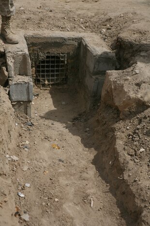 HABBANIYAH, Iraq (Aug. 21, 2008) – Citizens of Habbaniyah came together recently to improve a local clinic by constructing a drainage system, which will help with stagnate water that was collecting between the road and the Mudiq Clinic. Now, two cement drains sit on either end of the sloped section of ground directly in front of the clinic, forcing the water flow away from the entrance and into collection points. (Official U.S. Marine Corps photo by Lance Cpl. Scott Schmidt)