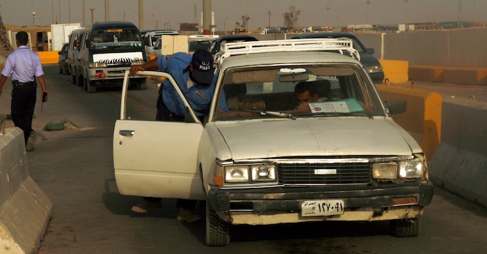 FALLUJAH, Iraq (Aug. 21, 2008) – An Iraqi Police officer searches a vehicle for illegal contraband at an entry control point outside Fallujah, Aug. 21. The ECPs throughout Fallujah are being reconstructed to allow greater traffic throughput for commercial and commuter vehicles. The project, in 3rd Battalion, 6th Marines area of operations, will encourage economic growth and serve as a convenience for local drivers. (Official U.S. Marine Corps photo by Cpl. Chris Lyttle) (RELEASED)