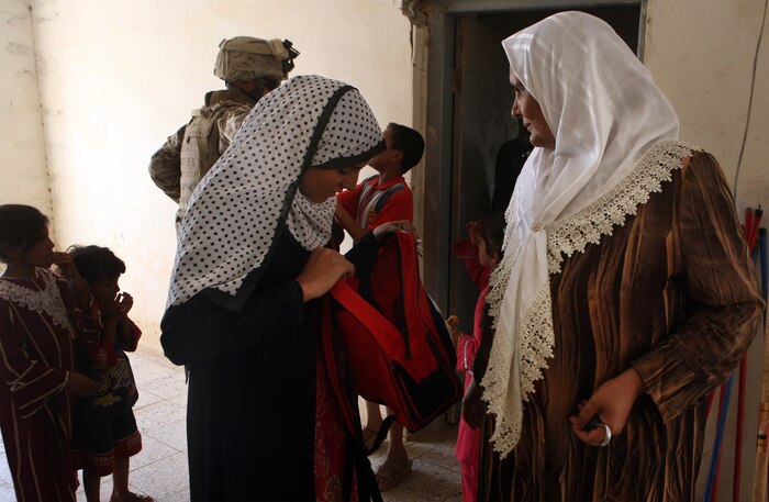 KHALIDYAH, Iraq (August 21, 2008) – Hamda Fauil Metap (right), the Khalidyah School’s head master and a teacher receive school supplies Aug. 21, from Marines with Company C, 1st Battalion, 2nd Marine Regiment, Regimental Combat Team 1. Metap has been teaching for 25 years says she has never seen a brighter future for the children than in recent months. (Official U.S. Marine Corps photo by Lance Cpl. Scott Schmidt)