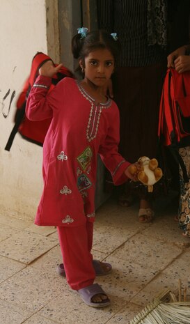 KHALIDYAH, Iraq (August 21, 2008) – An Iraqi girl swings her new backpack over her shoulder Aug. 21, which she will soon use on the first day of school. Teachers passed out school supplies and toys to the students after receiving them from Marines with Company C, 1st Battalion, 2nd Marine Regiment, Regimental Combat Team 1. (Official U.S. Marine Corps photo by Lance Cpl. Scott Schmidt)