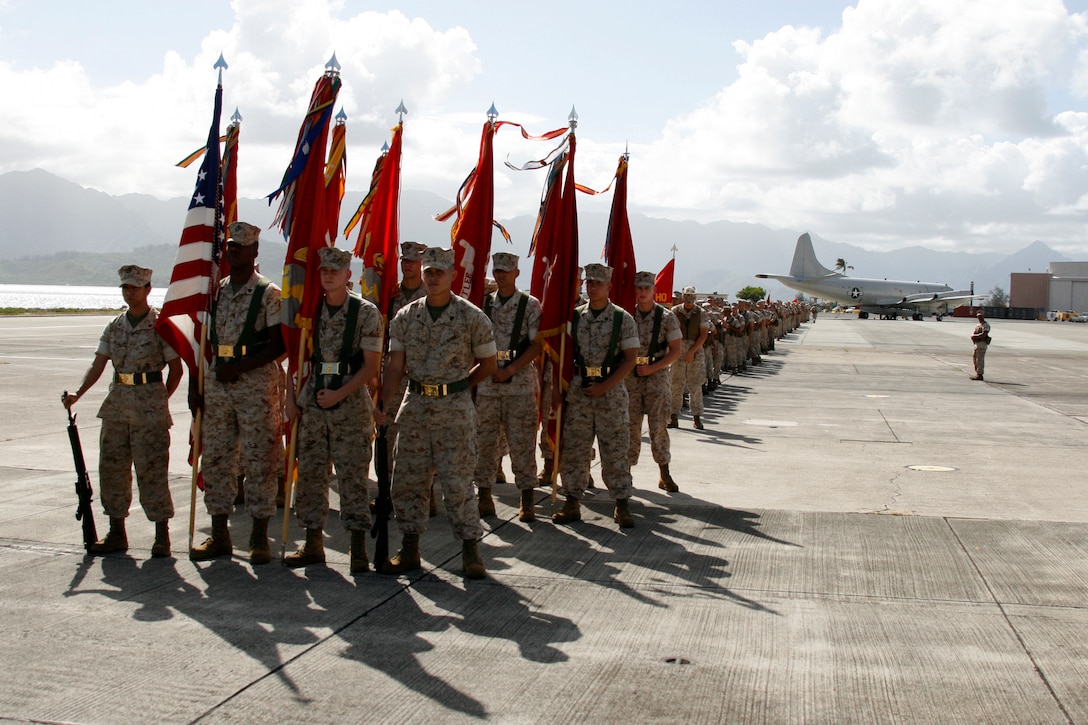 Color sergeants and a line of Marines representing the commands of U.S. Marine Corps Forces, Pacific stand ready to march on the flightline here Aug. 22 during the retirement and change of command ceremony for Lt. Gen. John F. Goodman, commander, MarForPac.