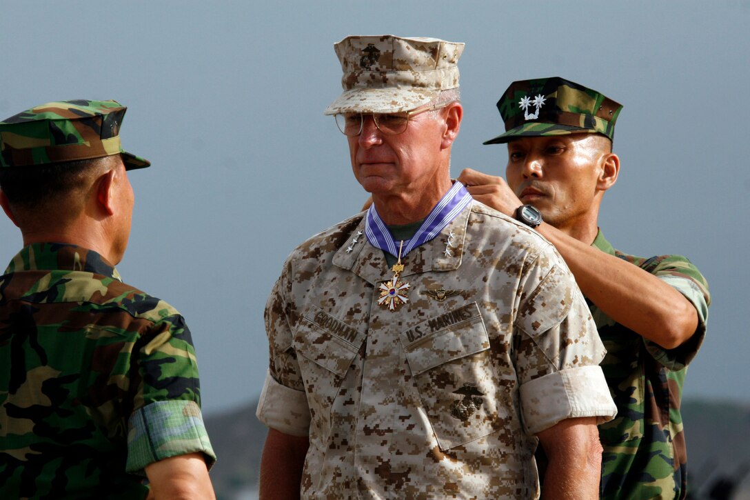 Lt. Gen. John F. Goodman, commander, U.S. Marine Corps Forces, Pacific, is awarded the Republic of Korea Order of National Security Merit (Gugseon) Medal during a change of command and retirement ceremony on the flightline here Aug. 22.