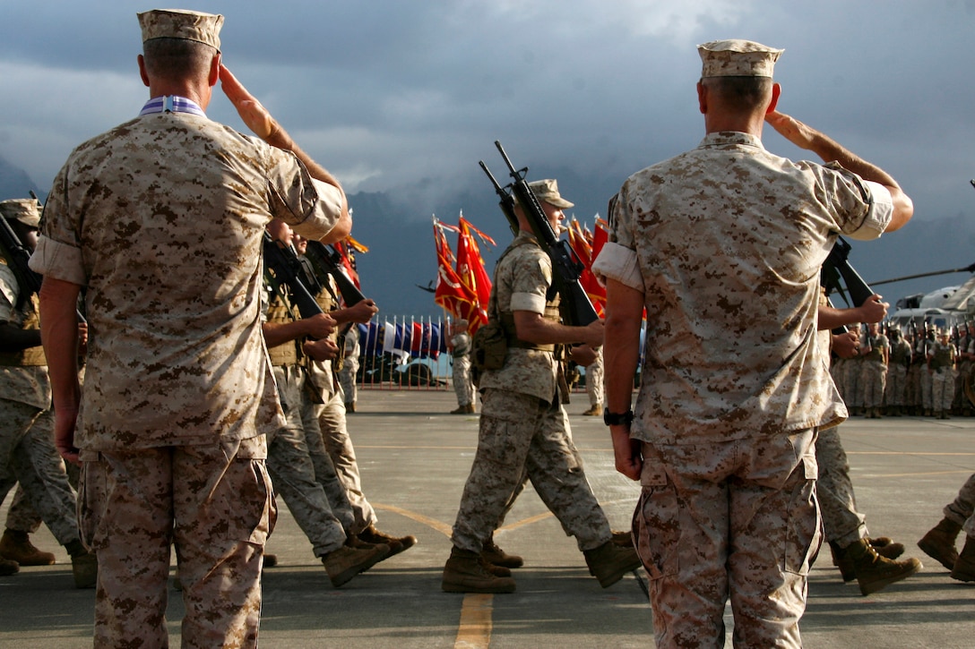 Lt. Gen. John F. Goodman, (left ) outgoing commander, U.S. Marine Corps Forces, Pacific, and Brig. Gen. Rex C. McMillian, (right) deputy commanding general, MarForPac, salute units as they pass before them during Goodman’s change of command and retirement ceremony at the flightline here Aug. 22.
