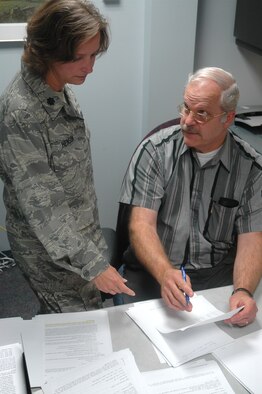 Lt. Col. Barb Henson, 446th Airlift Wing, McChord Air Force Base, Wash., goes over a financial matter with Bill Britt, 446th AW military pay supervisor.  Colonel Henson is the Reserve wing's Inspector General and one of the low-level stops Reservists should make when processing  official complaints or in need of assistance on any significant issues. (U.S. Air Force photo/Sandra Pishner)