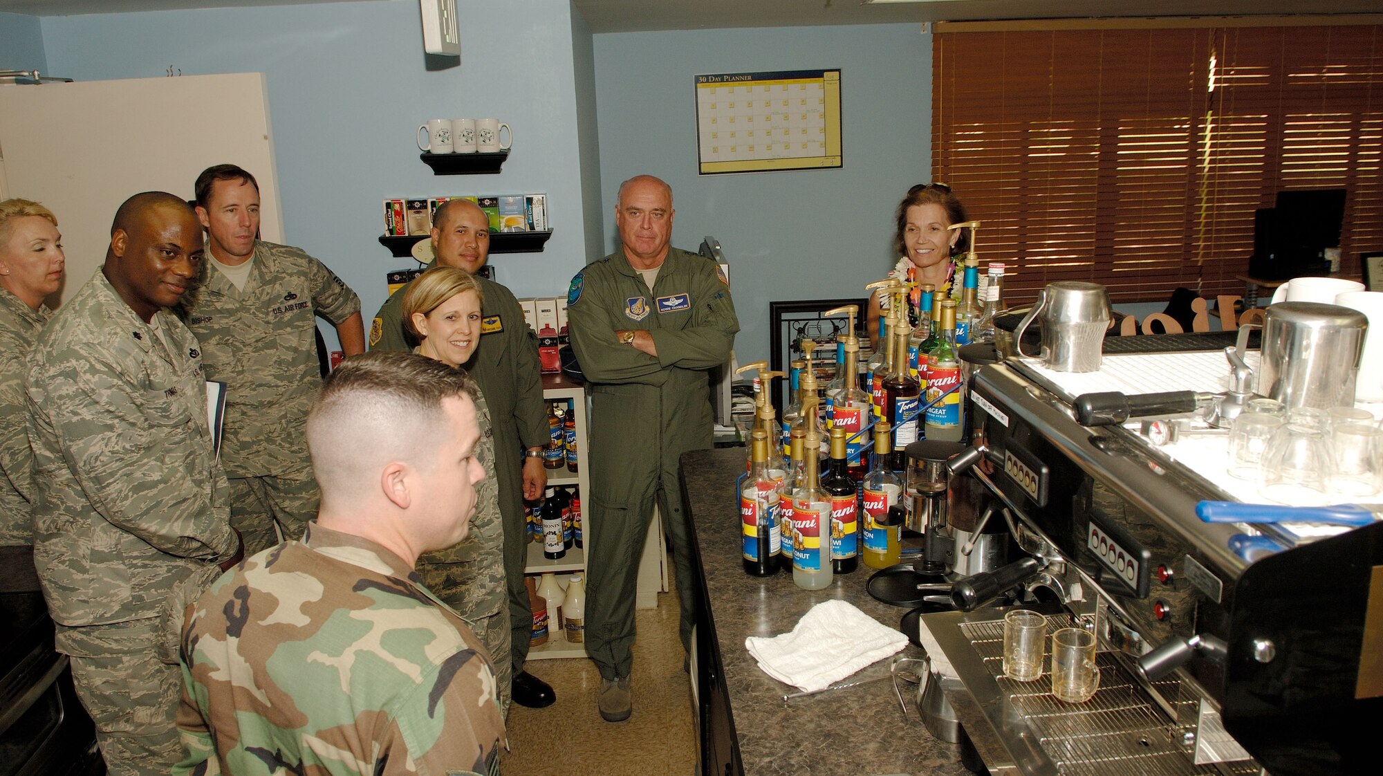 Getting a tour of the “Gathering Place” coffee shop from Tech. Sgt. Mike McCormick, 15th AMXS (front) are from left to right, Lt. Col Dwayne Thomas, 15th CES commander, Chief Master Sgt. Anthony Bishop, PACAF command chief, Maj. (Chaplain) Christine Blice-Baum, Col. Giovanni Tuck, 15th Airlift Wing commander, Gen. Carrol H.(Howie) Chandler, Commander Pacific Air Forces and Mrs. Chandler.  Gen.  Chandler and his wife, Eva-Marie, spent Monday touring 15th Airlift Wing organizations and talking with Team Hickam Airmen.  (U.S. Air Force photo/Mark Bates)