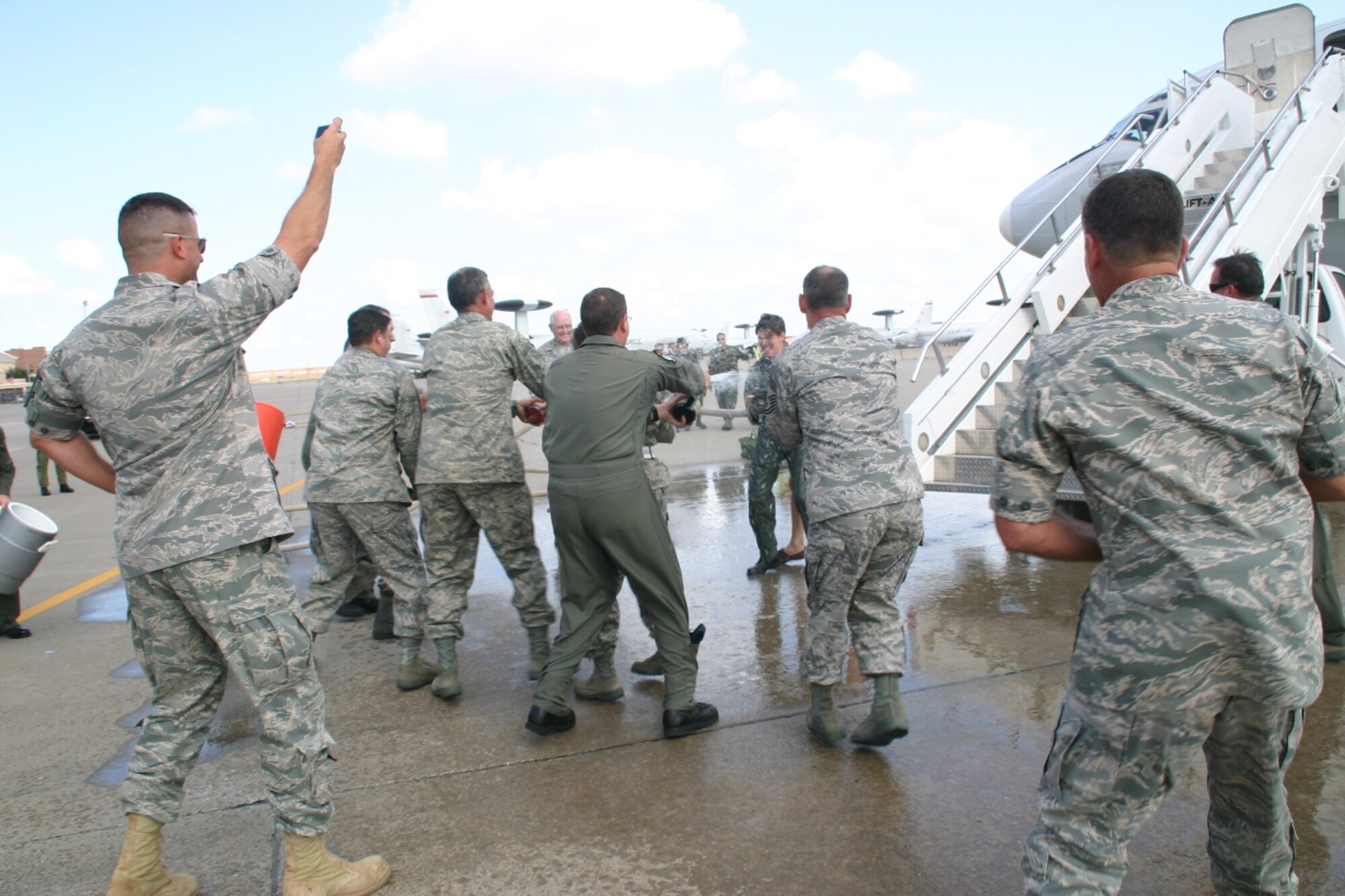 Brig. Gen. Lori Robinson, commander, 552 Air Control Wing, turned the fire hose on the hundreds of 552nd ACW Airmen, who congregated to celebrate General Robinson’s final flight on the E-3 as her role as the commander of the 552 ACW comes to an end. (Photo Courtesy of 2nd Lt. Kinder Blacke)