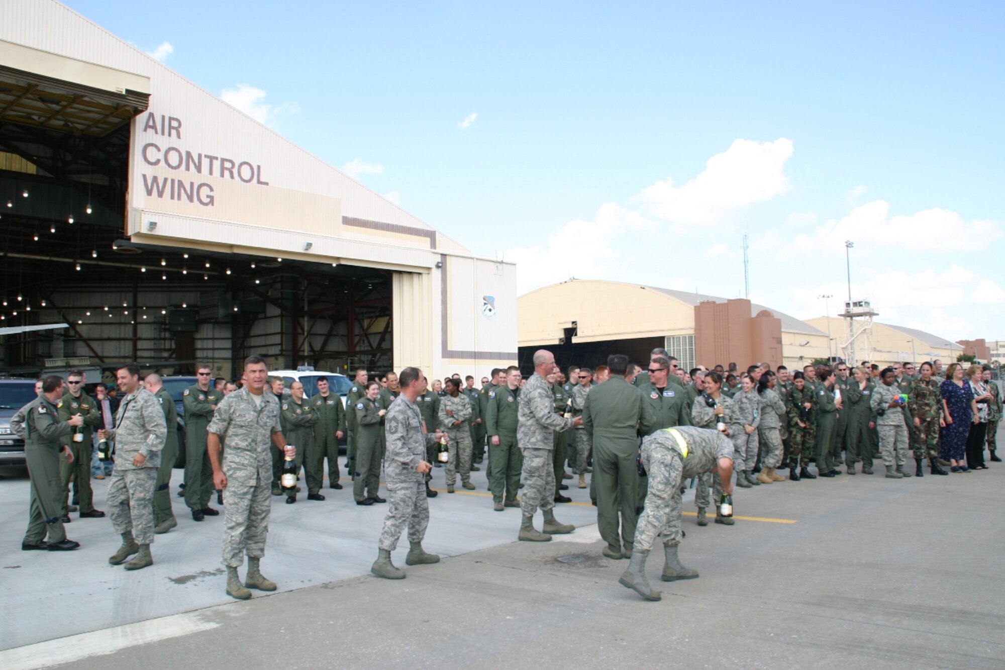 Hundreds of Airmen from the 552nd Air Control Wing and other units on base wait in anticipation for the wing commander's fini flight to arrive.