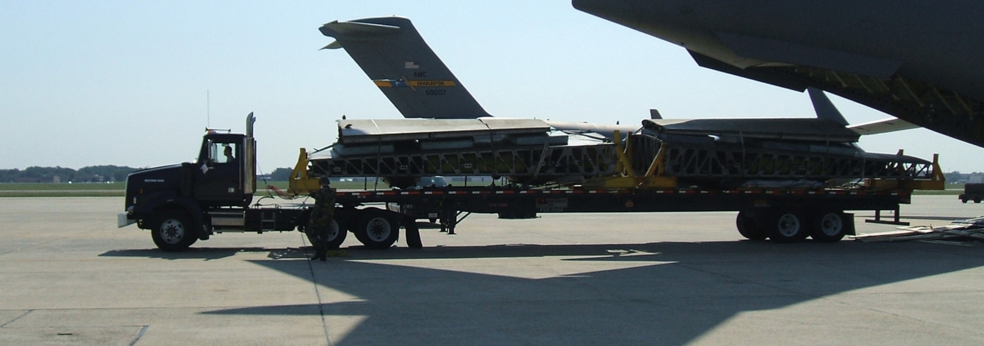 A driver prepares to back a flatbed truck onto a C-17 Globemaster recently. The truck holds the wings of “The Swoose,” the oldest surviving B-17 Flying Fortress, which left Andrews Aug. 4 for Dayton, Ohio. “The Swoose” will be assembled and put on display at the National Museum of the U.S. Air Force. (Courtesy Photo)