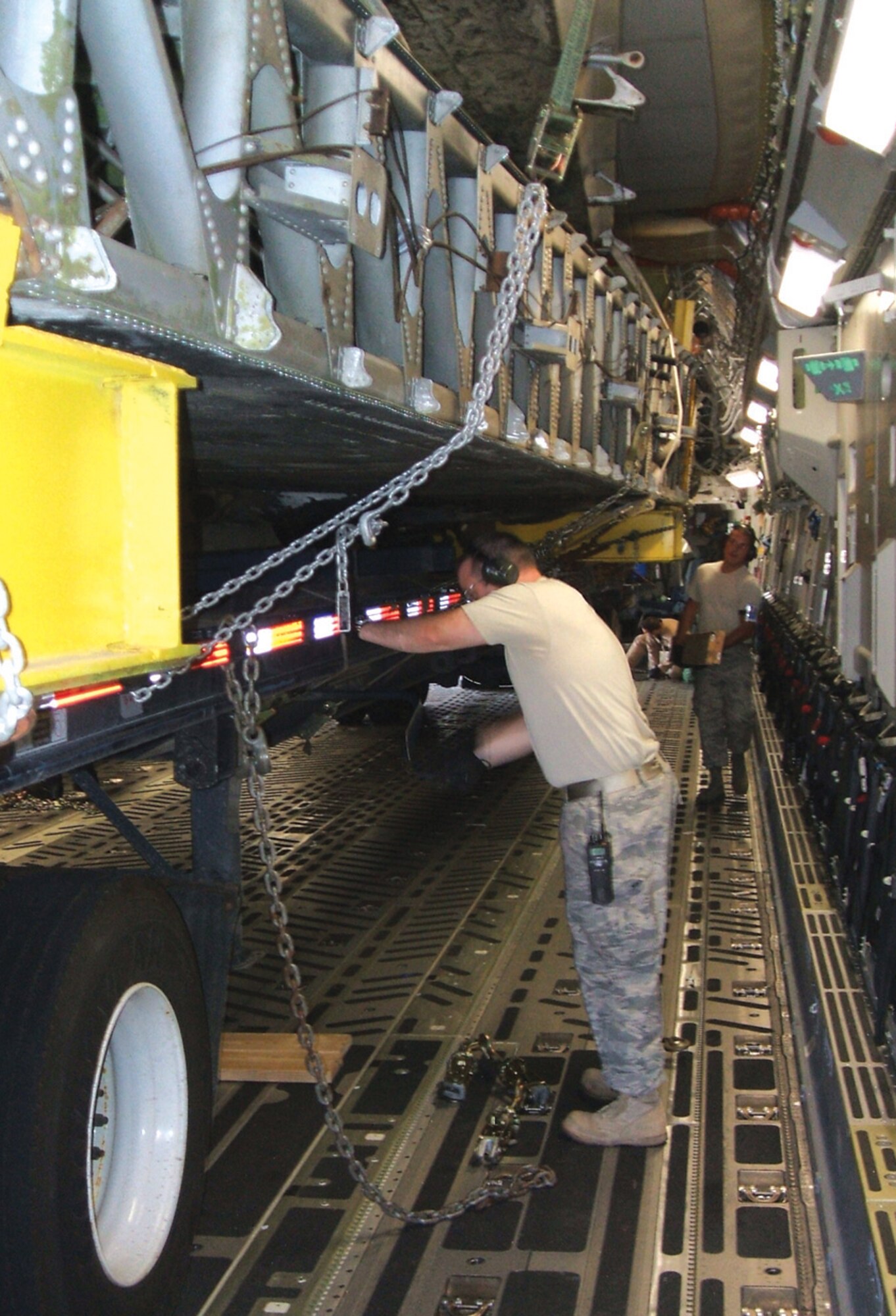 Tech. Sgt. Daryl Stringer, center, lowers the landing gear on a flatbed truck as Senior Airman Matthew Ounan moves equipment onboard a C-17 Globemaster recently. Both are members of the 89th Aerial Port Squadron. The truck holds the wings of “The Swoose,” the oldest surviving B-17 Flying Fortress, which left Andrews Aug. 4 for Dayton, Ohio. “The Swoose” will be assembled and put on display at the National Museum of the U.S. Air Force. (Courtesy Photo)