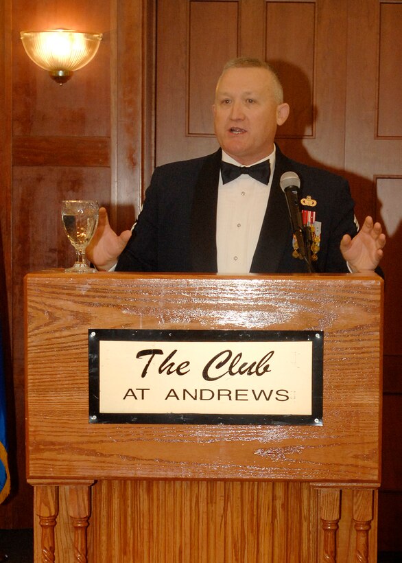 Chief Master Sgt. Paul Wheeler, Air Force District of Washington command chief, speaks to the crowd at the senior non commissioned officer induction ceremony Aug. 18 at The Club at Andrews. Chief Wheeler's speech was on three words in the Airman's Creed, “Wingman, Leader, Warrior.” The senior NCO induction ceremony is held annually for all new master sergeants. That evening 42 new master sergeants from around the National Capital Region were inducted. (U.S. Air Force photo by Senior Airman Melissa Stonecipher)