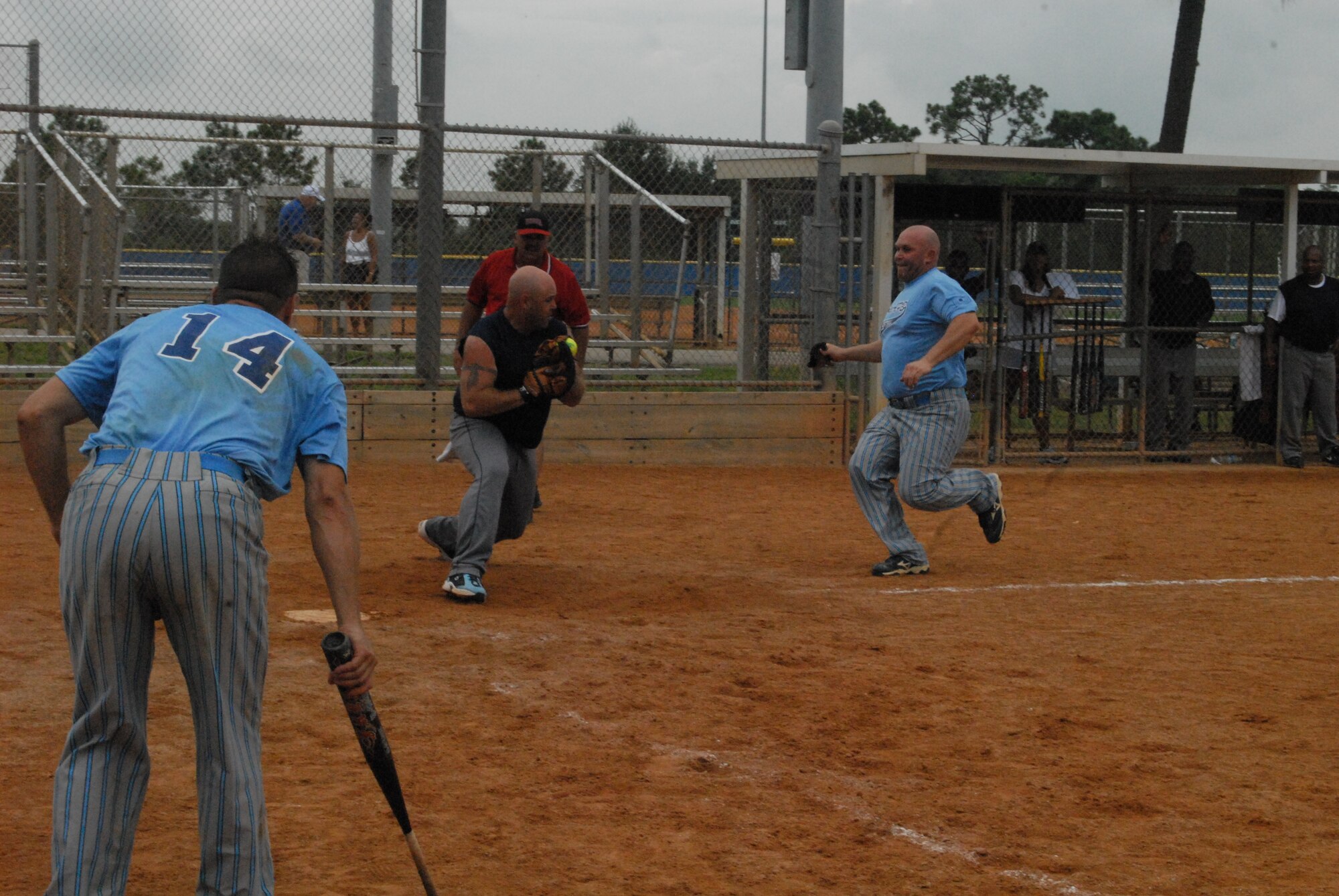 Staff Sgt. Jason Bender, a member of a Joint Special Operations Command tenant unit at Pope Air Force Base, N.C., starts his slide into home plate during a game August 16 against Fort Gordon, Ga. Sergeant Bender was a member of the Pope team that finished 2nd at the Military Softball World Series in Kissimmee, Fla. (U.S. Air Force Photo by 2nd Lt. Chris Hoyler)