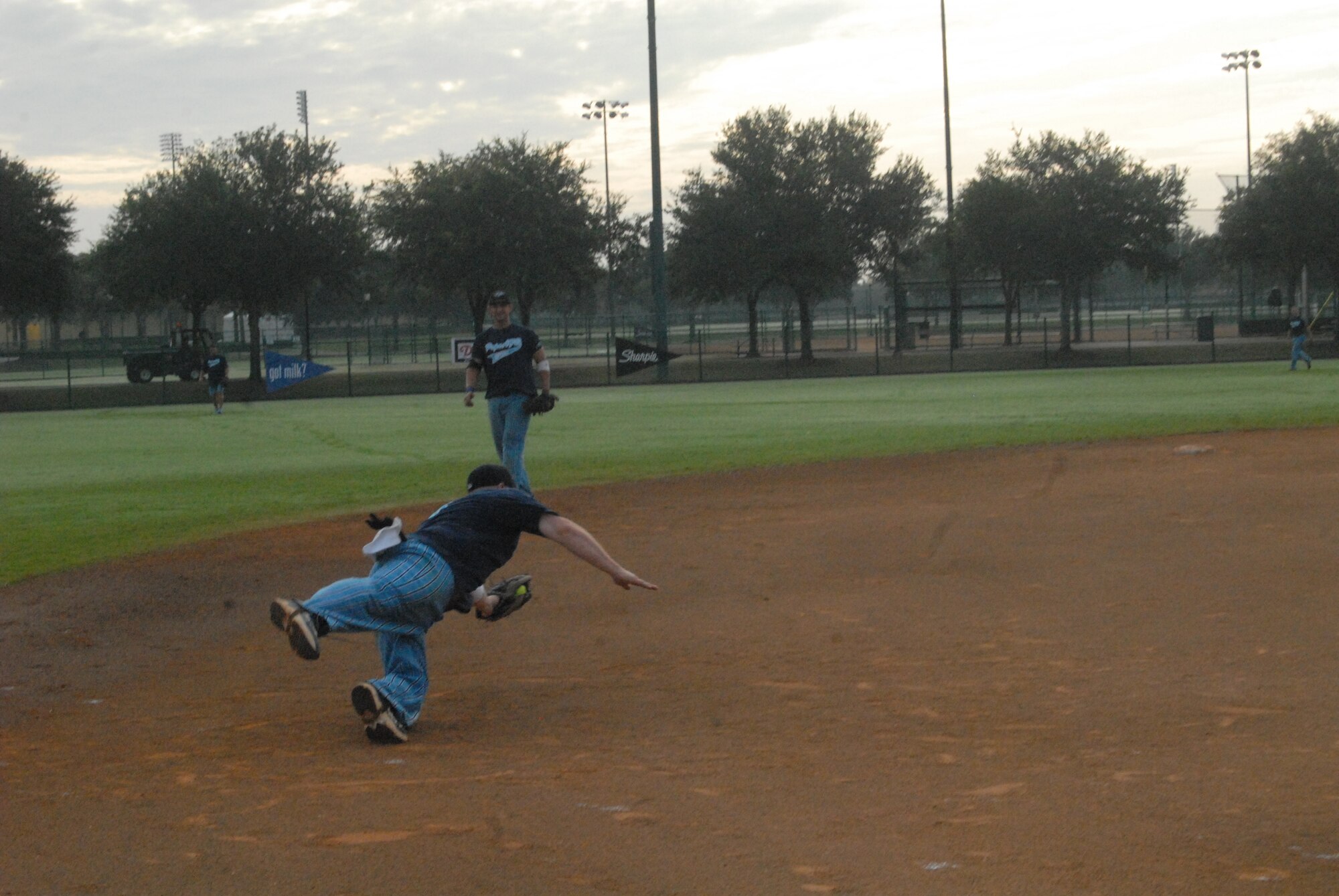 Senior Airman Jake Rutherford, 2nd Airlift Squadron and member of the Pope Air Force Base All-Star Softball Team, makes a diving stop at third base August 17 during the team's giving against MacDill AFB, Fla. at the Military Softball World Series in Kissimmee, Fla. (U.S. Air Force Photo by 2nd Lt. Chris Hoyler)