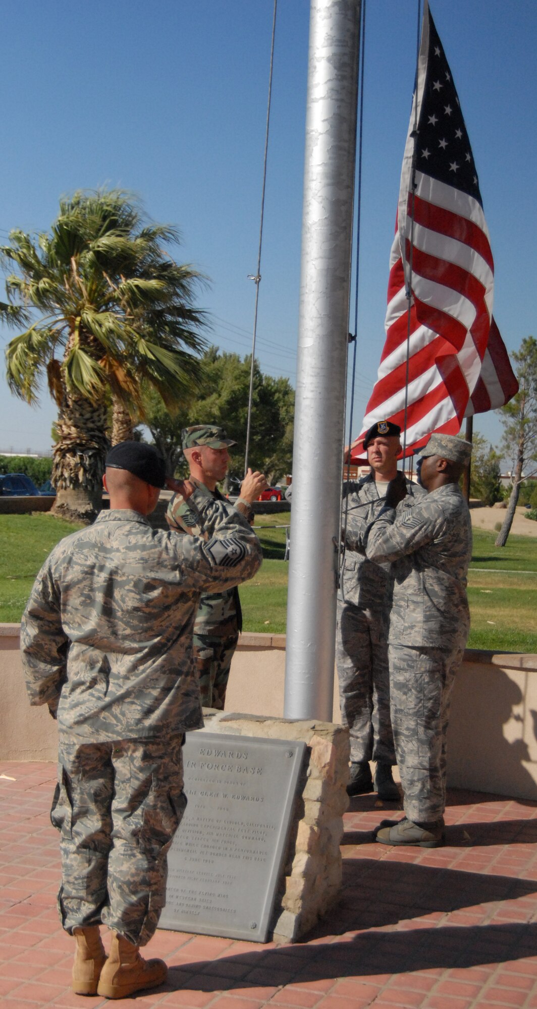 Team Edwards senior Noncommissioned Officers Professional Development Course students lower the flag during a retreat ceremony in front of the Air Force Flight Test Center here Aug. 21. (Air Force photo by Airman 1st Class William O'Brien)
