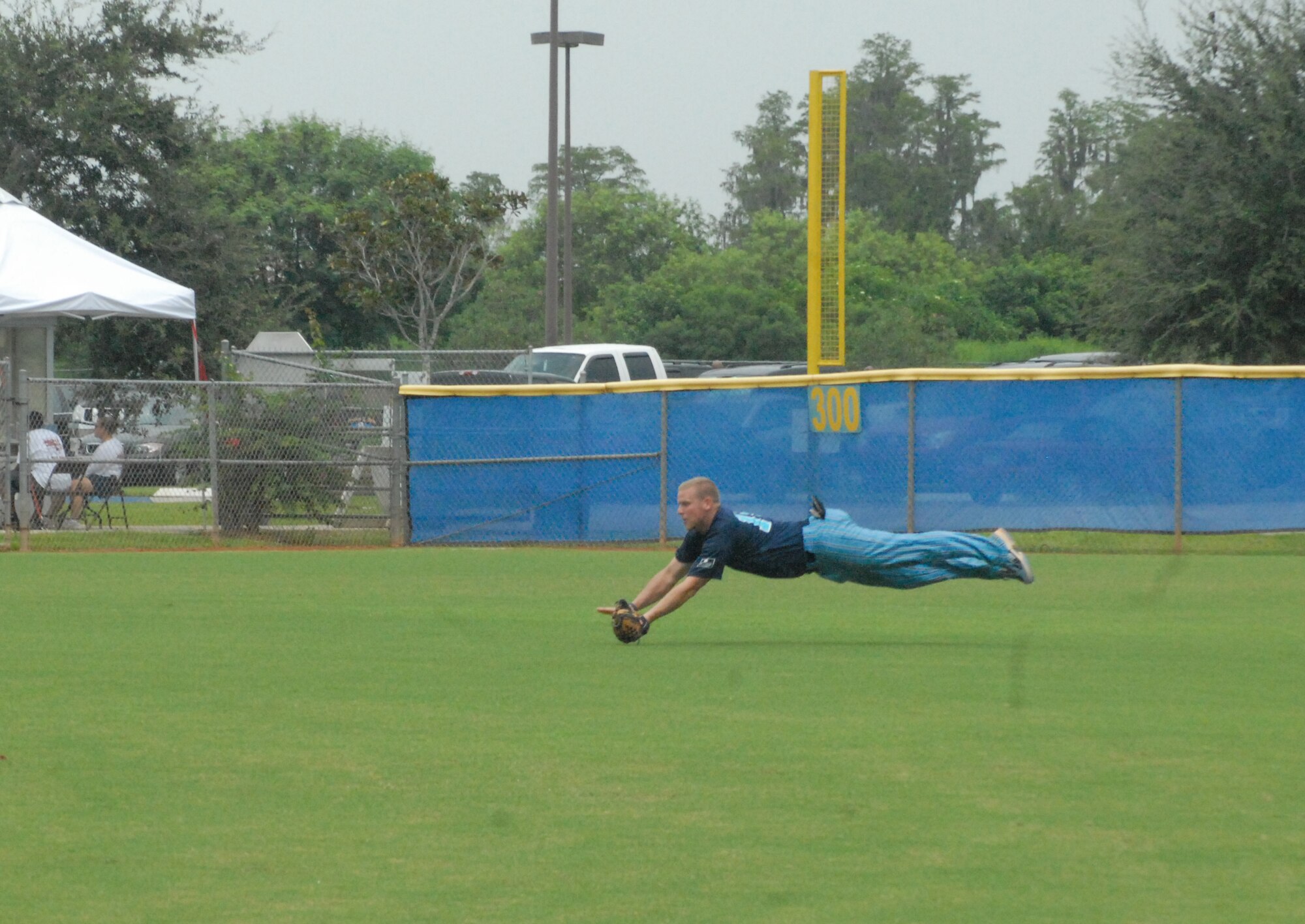 Staff Sgt. Adam Jessee, 43rd Security Forces Squadron and member of the Pope Air Force Base All-Star Softball Team, makes a diving catch in left-centerfield against the Fort Bliss team August 16 at the Military Softball World Series in Kissimmee, Fla. (U.S. Air Force Photo by 2nd Lt. Chris Hoyler)