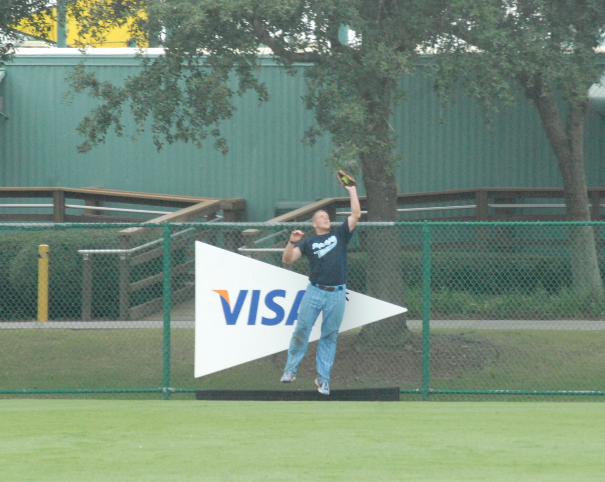 Staff Sgt. Adam Jessee, 43rd Security Forces Squadron and member of the Pope Air Force Base All-Star Softball Team, makes a leaping catch in center field against the MacDill Air Force Base, Fla. team August 17 at the Military Softball World Series at the Disney Wide World of Sports Complex in Kissimmee, Fla. (U.S. Air Force Photo by 2nd Lt. Chris Hoyler)