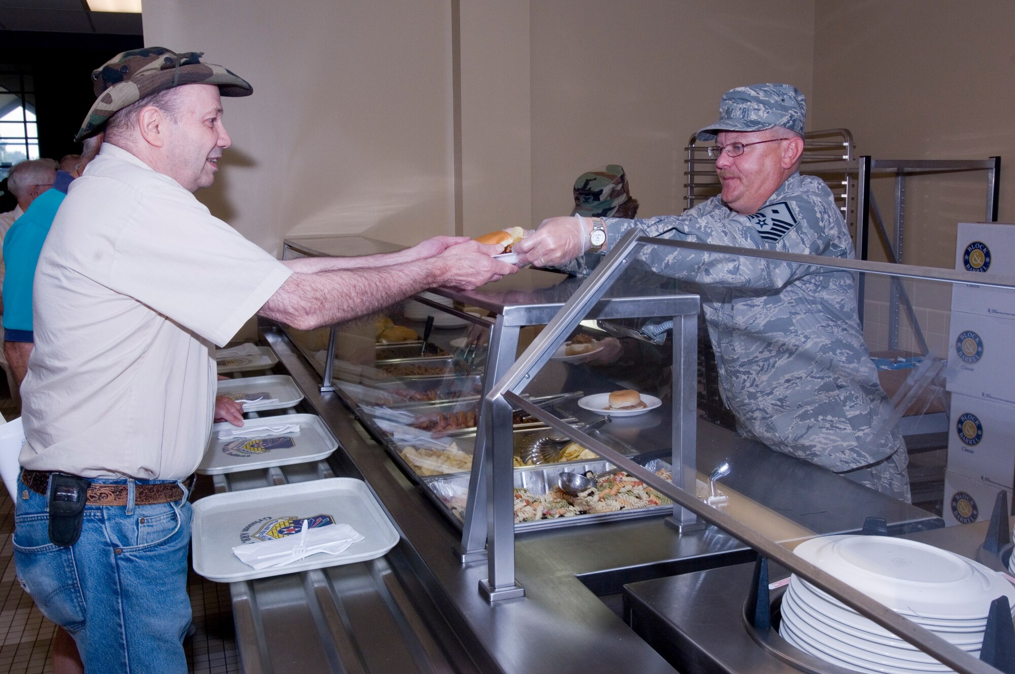 GRISSOM AIR RESERVE BASE, Ind., -- Master Sgt. Geoffrey Spaulding, a first sergeant with the 49th Aerial Port Squadron, serves food to Dennis Redding, during the annual Military Retiree Appreciation Day held in August.  Military retirees from all branches were invited to the base to participate in an information fair, luncheon and take advantage of a special commissary sale. (U.S. Air Force photo/ Tech. Sgt. Doug Hays)