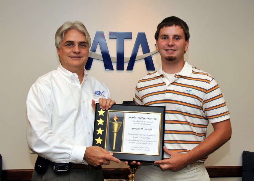 Dr. David Elrod, Aerospace Testing Alliance (ATA) General Manager at the U.S. Air Force's Arnold Engineering Development Center (AEDC), presents a $3,000 Jacobs Technology scholarship to James Routh, Jr. Routh, son of ATA's James Routh, is a sophomore at the University of Tennessee in Knoxville. ATA is the support contractor for  the center. (Photo by David Housch)
