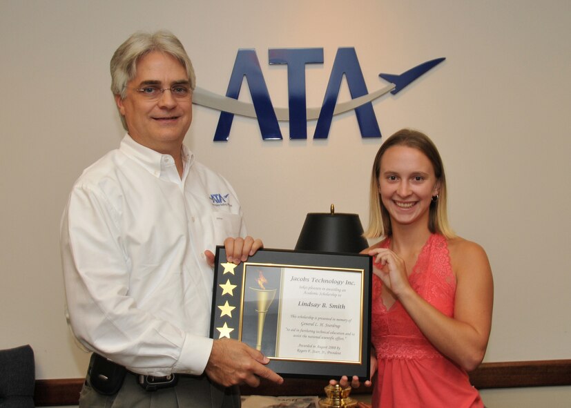 Dr. David Elrod, Aerospace Testing Alliance (ATA) General Manager at the U.S. Air Force's Arnold Engineering Development Center (AEDC), presents a $3,000 Jacobs Technology scholarship to Lindsay Smith. Smith, daughter of ATA's Gary Meuer, is a junior at Tennessee Technological University in Cookeville. ATA is the support contractor for the center. (Photo by David Housch)
