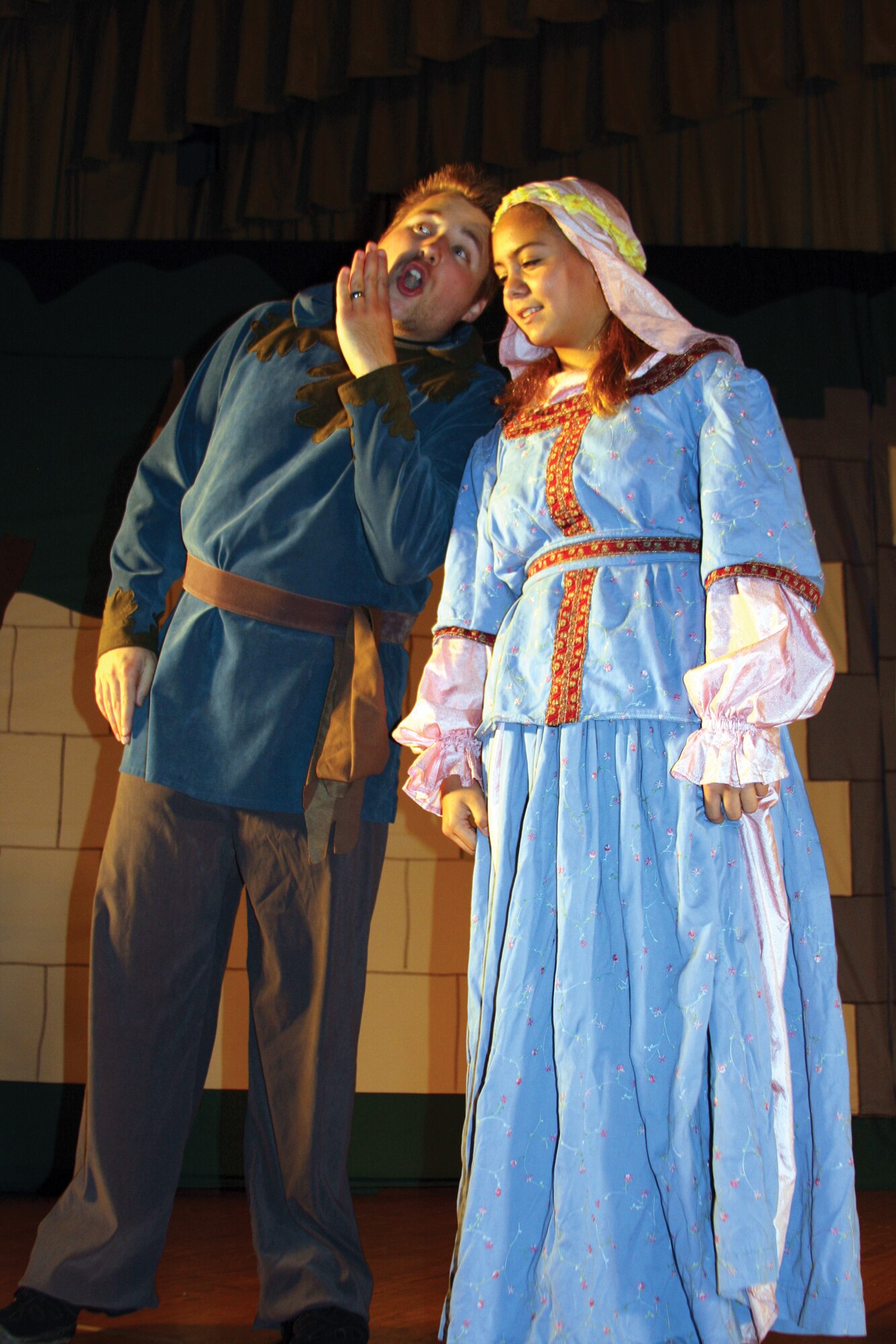 Sherwood of the Forest (Evan Karlewicz) confers with Maid Marion (Stephanie Brown). during the dress rehearsal for the Missoula Children’s Theatre production of Robin Hood Aug. 15 at the base theater. The cast auditioned for the show Aug. 11 and were ready to perform by Aug. 16. (U.S. Air Force photo by Julie Manuel)