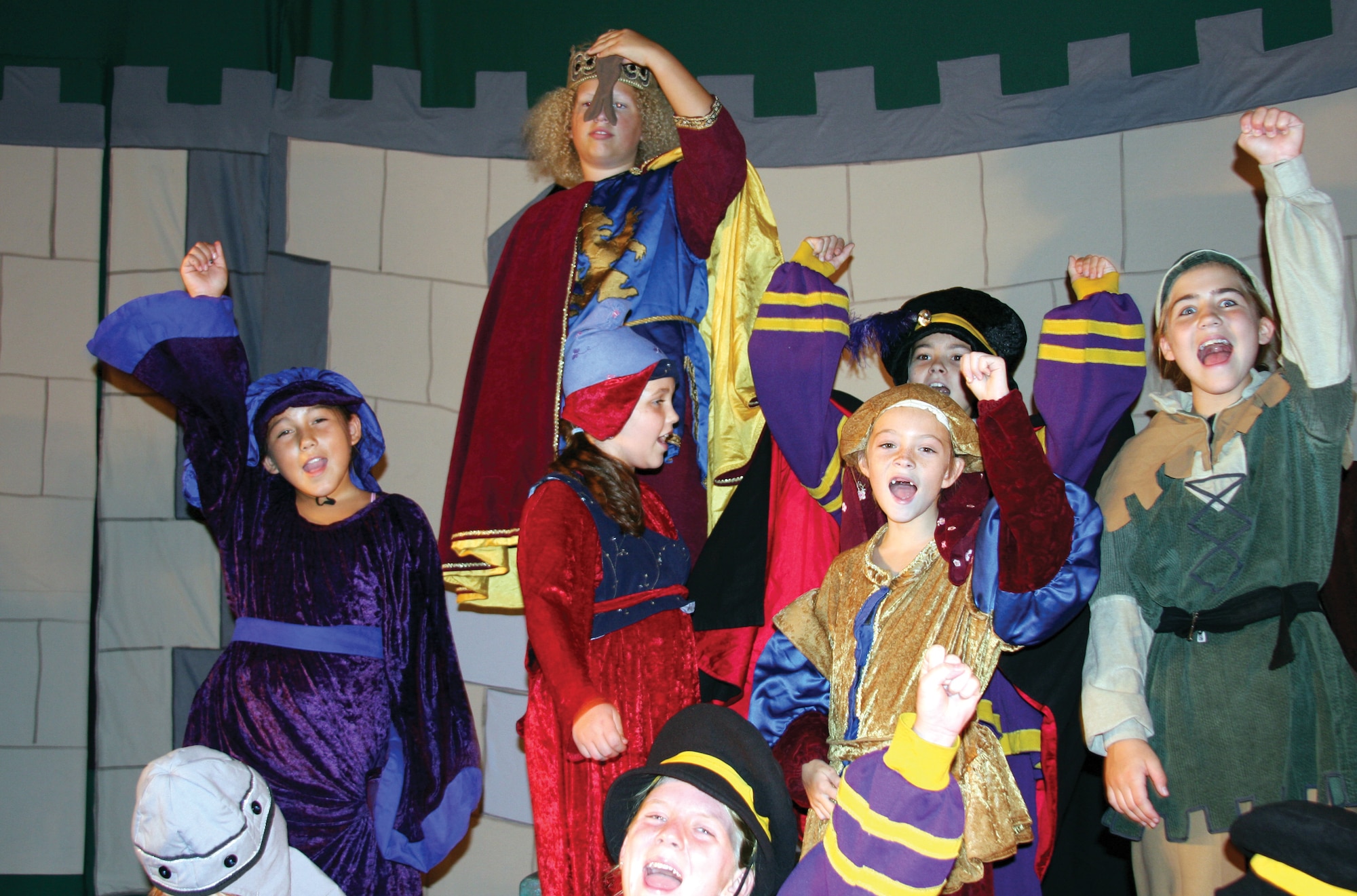 Prince John (center top, played by Emma Wirtz) and his court, along with Robin Hood (right, played by Emily Lescarbeau), sing during the dress rehearsal for the Missoula Children’s Theatre production of Robin Hood Aug. 15 at the base theater. The cast auditioned for the show Aug. 11 and were ready to perform by Aug. 16. (U.S. Air Force photo by Julie Manuel)