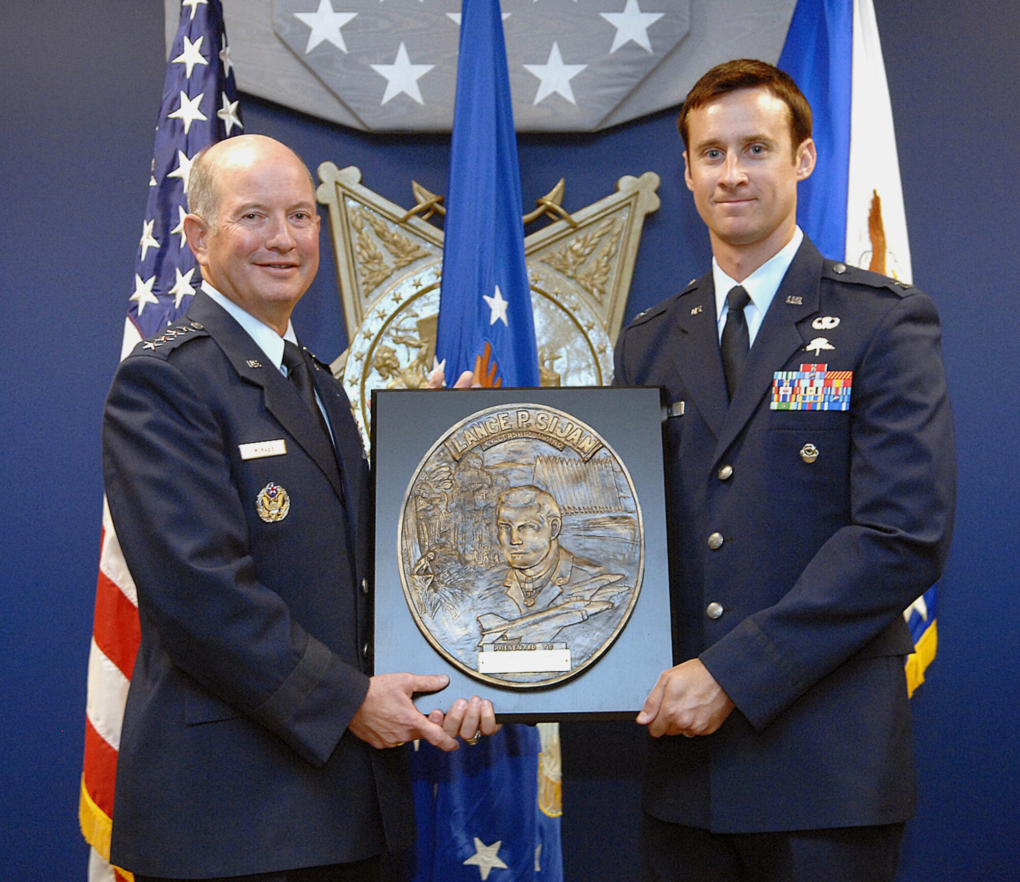 Vice Chief of Staff of the Air Force Gen. Duncan J. McNabb presents the Lance P. Sijan Air Force Leadership Award to Capt. Steward J. Parker in a ceremony Aug. 20 at the Pentagon. Captain Parker is a special tactics officer assigned to the 21st Special Tactics Squadron at Pope Air Force Base, N.C. The Sijan Award recognizes Airmen who demonstrated outstanding leadership while assigned to an organization at the wing level or below. (U.S. Air Force photo/Andy Morataya) 
