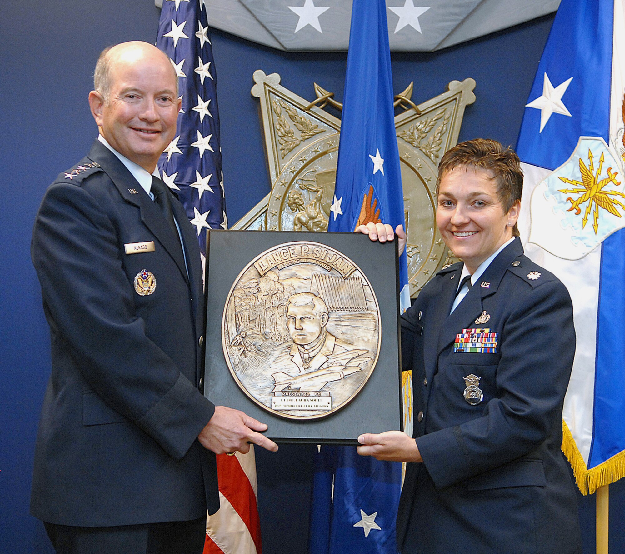 Vice Chief of Staff of the Air Force Gen. Duncan J. McNabb presents the Lance P. Sijan Air Force Leadership Award to Lt. Col. Laura A. Soule in a ceremony Aug. 20 at the Pentagon. Colonel Soule is the commander of the 37th Security Forces Squadron at Lackland Air Force Base, Texas. The Sijan Award recognizes Airmen who demonstrated outstanding leadership while assigned to an organization at the wing level or below. (U.S. Air Force photo/Andy Morataya) 
