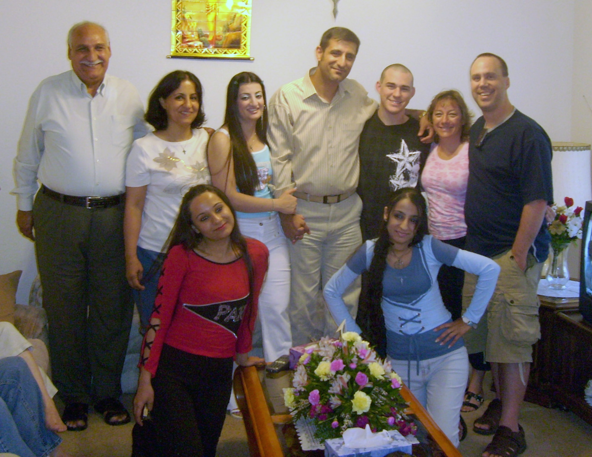 Surrounded by his family and friends, Vincent Talia (center)  and his wife Nouras, celebrated their first American wedding anniversary in Colorado. The celebration was attended by Master Sgt. Greg Jensen (far right) and his family. Sergeant Jensen helped Mr. Talia, an Iraqi citizen, to obtain an American visa through a special program for armed forces interpreters. The two worked together in Basra in support of Operation Iraqi Freedom during 2006.  (Courtesy photo) 