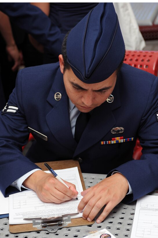 Airman 1st Class Luciano Amaza, Air Force Financial Services Center temporary duty technician, takes the first step in voicing his opinion as a new American citizen by registering to vote at Mount Rushmore National Memorial, S.D., Aug. 2.  Out of the 33 American citizens that took part in the ceremony, five are Airmen from Ellsworth. (U.S. Air Force photo /Airman 1st Class Adam Grant) 



