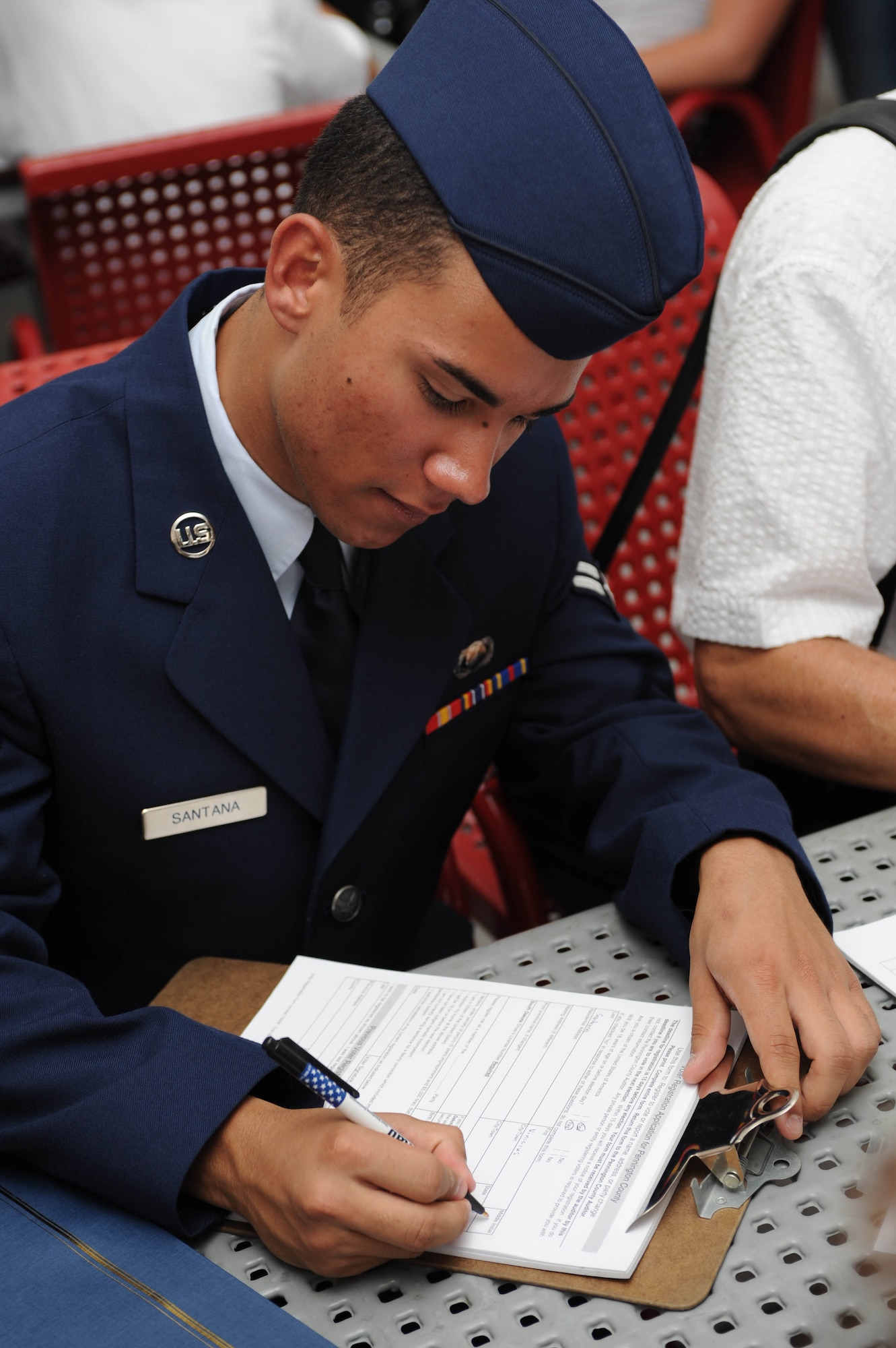 Airman 1st Class Vinicius Santana, Air Force Financial Services Center travel pay technician, takes the first step in voicing his opinion as a new American citizen by registering to vote at Mount Rushmore National Memorial, S.D., Aug. 21.  Out of the 33 American citizens that took part in the ceremony, five are Airmen from Ellsworth. (U.S. Air Force photo/Airman 1st Class Adam Grant) 

