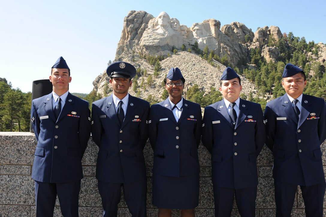 Five Airmen from Ellsworth took the last step to become United States citizens by swearing the oath of allegiance at Mount Rushmore National Memorial, S.D., Aug. 21. From left to right, America's newest citizens are: Airmen 1st Class Vinicius Santana, Sanaka Patrick, Luciano Amaza, Ronald Fallarna, all assigned to the Air Force Financial Service Center, and Airman 1st Class Tarun John, 28th Civil Engineer Squadron. (U.S. Air Force photo /Airman 1st Class Adam Grant)
