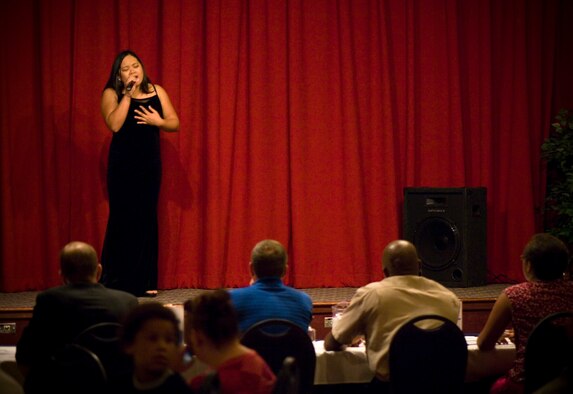 FAIRCHILD AIR FORCE BASE, Wash. – Yolonda Collins, 92nd Services Squadron civilian contractor, sings candidly to the crowd as she competes against nine other contenders for the top-qualifying position during AMC Icon here Aug. 15. After the event, the top three contenders won cash prizes – $500, $300 and $200, respectively; and the first place winner, Airman 1st Class Johanna Brooks, 141st Air Refueling Wing, will be flown to Scott Air Force Base, Ill., to compete against 11 other Airmen from Air Mobility Command, each of whom won first place prizes at their constituent bases. (U.S. Air Force photo / Airman 1st Class Joshua K. Chapman)