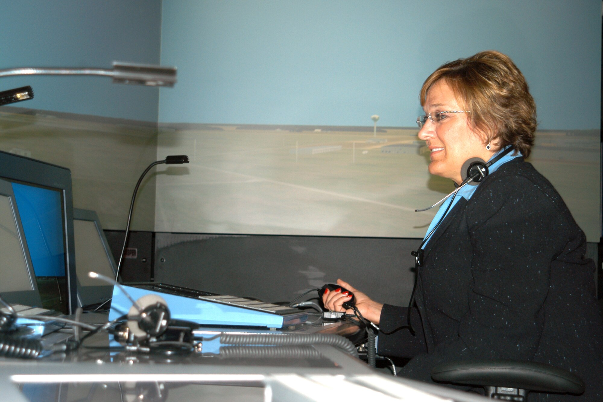GRISSOM AIR RESERVE BASE, Ind., -- Cathy Gallmeyer, the regional director for Senator Richard Lugar, tries her hand at being an air traffic controller at the ATC simulator here Aug. 21. Ms. Gallmeyer, and other congressional staffers visited the base to learn more about the base and its activities. (U.S. Air Force photo/Capt. Kelly Howard)