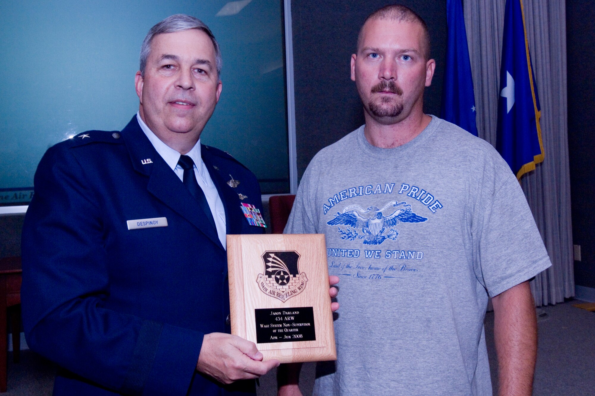 GRISSOM AIR RESERVE BASE, Ind., -- Brig. Gen. Dean Despinoy, 434th Air Refueling Wing commander, left, presents a plaque to Jason Darland, 434th Maintenance Squadron, for his selection as the Wage System Non-Supervisor of the Quarter. The presentation was made as part of a civilian commander's call held recently. (U.S. Air Force photo/Tech. Sgt. Doug Hays)